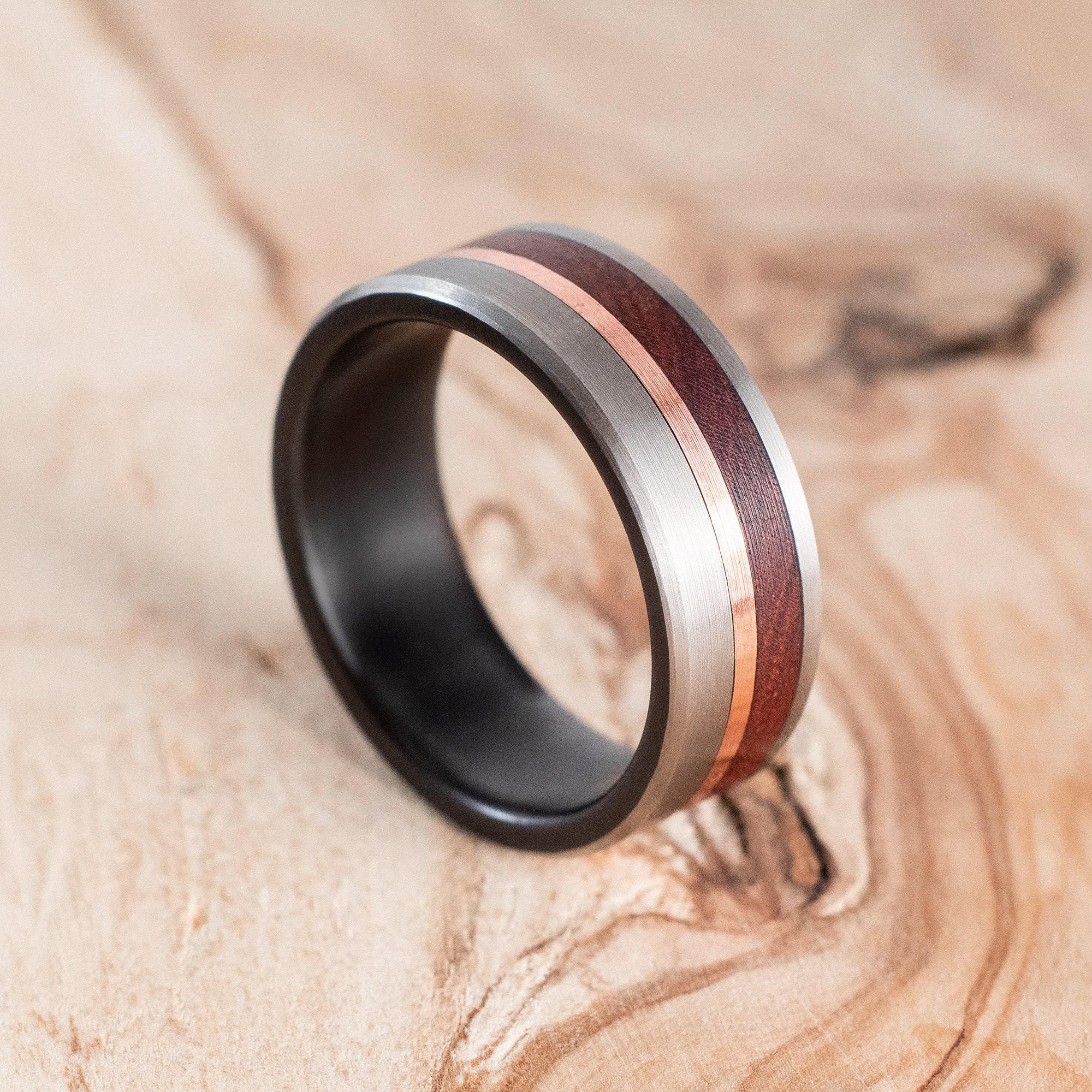 Fire-blackened titanium with copper liner and Mopane wood ring. Engagement ring, wedding ring.